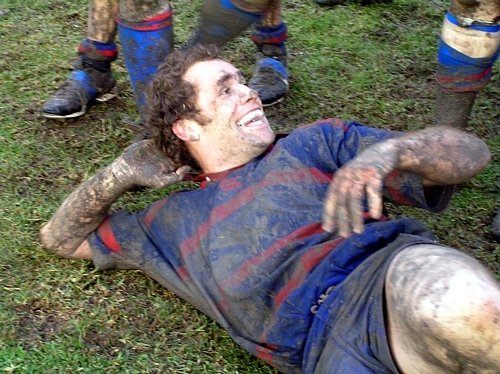 Andy Farquharson reclining in mud